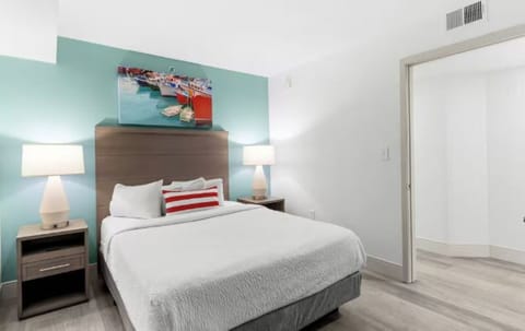 Unwind in crisp linens under soft, warm bedside lighting.