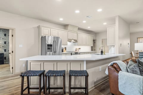 Bright, fully equipped kitchen with expansive counters and modern finishes.