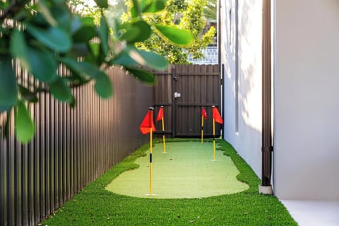Putting green with adult and child putters.