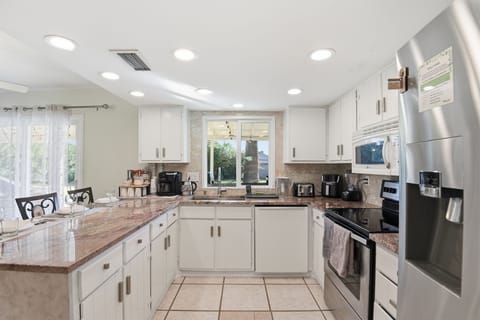 Kitchen with modern appliances, generous counter space & all essential cookware