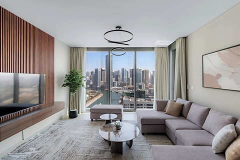 Relax in this luxurious living space with stunning city and Canal views, modern lighting, and an open layout perfect for relaxation or entertaining guests.