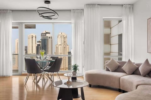 ✨ Bright living and dining space with floor-to-ceiling windows, offering stunning Dubai Marina views. Relax on the stylish sofa or enjoy meals with the city skyline as your backdrop.