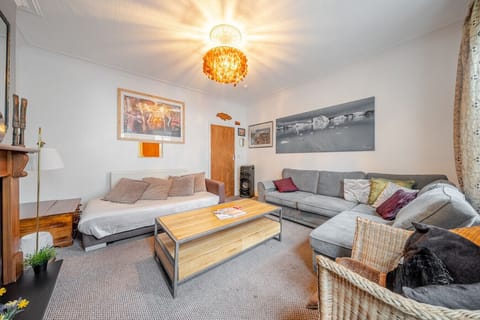 Spacious living room with sofas, coffee table, and ceiling light feature