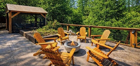 Gather around the gas firepit in style, surrounded by comfortable Adirondack chairs for the perfect evening outdoors.