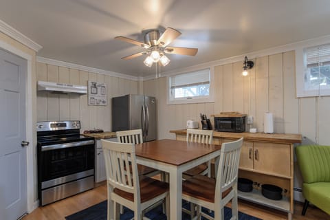 Dining area designed for comfort and connection, with a fully equipped kitchen just within reach.