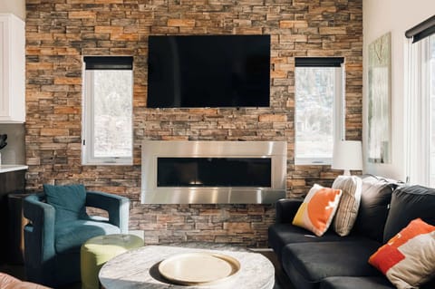 Living area with sectional sofa seating & flatscreen TV (the fireplace is out of order & not available for guest use)