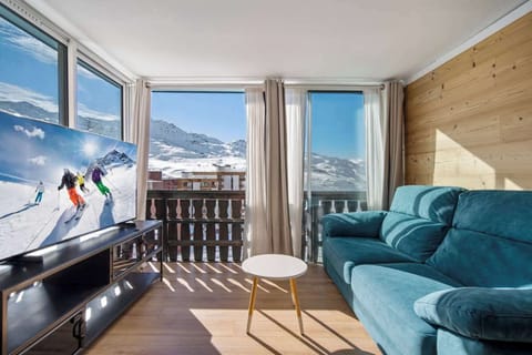 Wake up to panoramic mountain views and morning light filling your cozy alpine living space