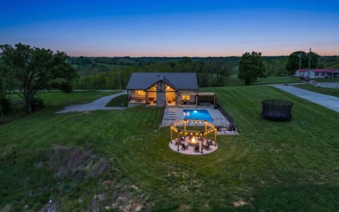Picture
your whole group
scattered across
the property from
above — the pool
and fire pit circle
sit inside your own
ten acres.