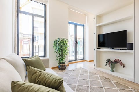 Living Area with sofa-bed, TV and AC.