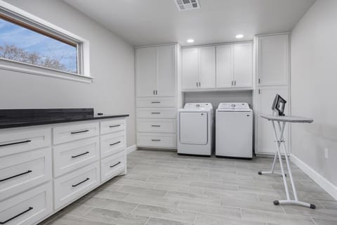 Laundry area with ironing board and iron
