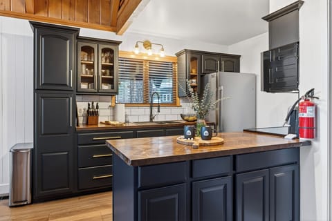 Gourmet kitchen featuring modern appliances and dark cabinetry.
