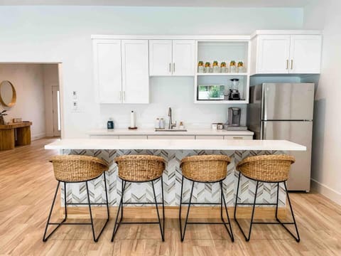 The entertainment room kitchenette on the first floor has a full size refrigerator, sink, and microwave, along with a bar with seating for 4. 