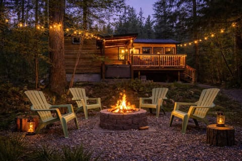 Cozy outdoor fire pit retreat with string lights and seating