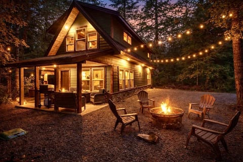 Cozy cabin retreat with glowing firepit and string lights