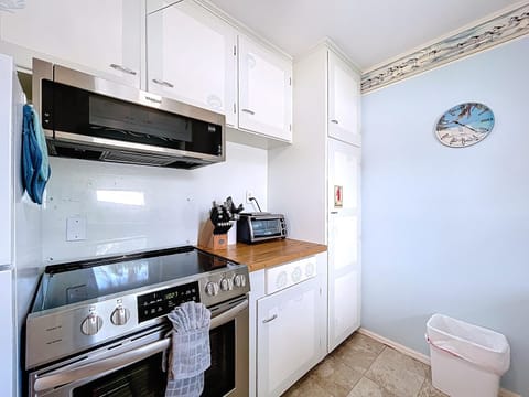 Kitchen with an electric smooth top range and microwave