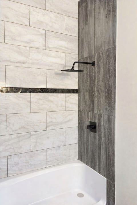 Hand laid tile to ceiling in large showers for each en suite bedroom