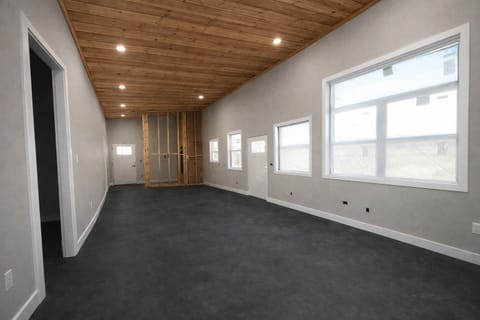 Under construction: Extra large well lit open concept living room and kitchen