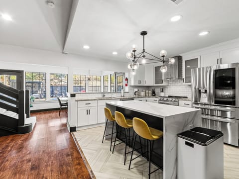 Your gourmet kitchen features marble countertops, modern appliances, and a stylish island where you can sip coffee while sunlight streams through large windows.
