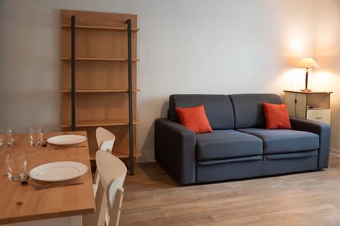 A comfortable living area with a sofa and dining space, ideal for relaxing and sharing meals.