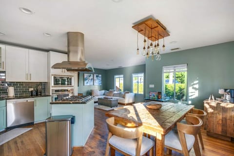 Bright open-concept kitchen and dining area with modern appliances and natural light.
