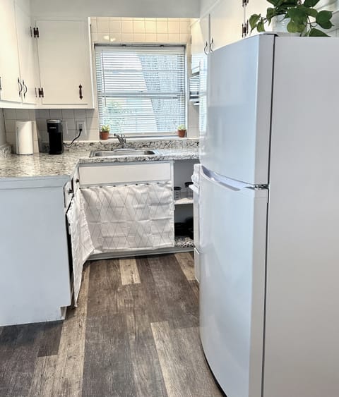 Fully stocked kitchen with oven / stove, full fridge, microwave, and Keurig. 