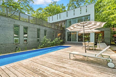 Heated lap pool and glass-walled house in private woods