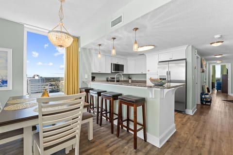 A large window beside the bar fills the space with natural light throughout the day.