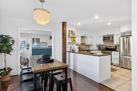 Bright dining nook with a farmhouse table, modern seating, and easy flow into the kitchen—ideal for shared meals and casual gatherings.
