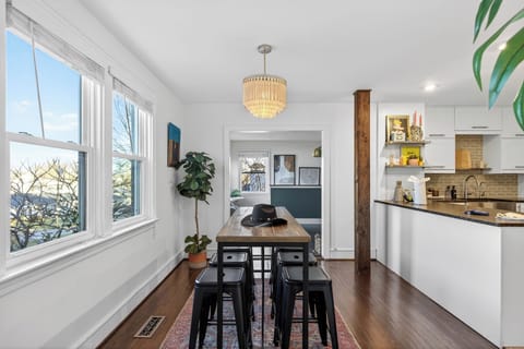 Bright dining nook with a farmhouse table, modern seating, and easy flow into the kitchen—ideal for shared meals and casual gatherings.