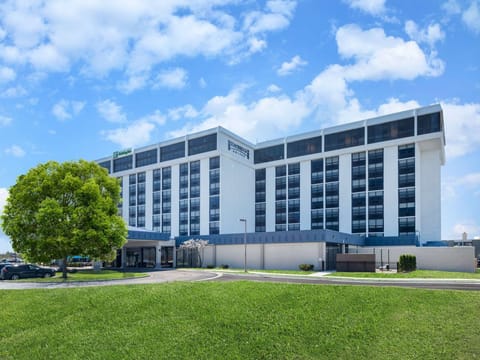 Wide exterior view with green lawn and clear blue sky