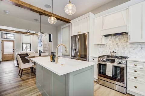 Culinary enthusiasts will love the professional grade gas range and elegant marble tile backsplash. This kitchen is equipped with high end stainless steel appliances and ample counter space for preparing delicious home cooked meals..