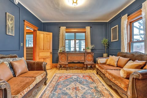 Charming, light-filled reading room with classic vintage details, rich wood trim, and cozy seating.
