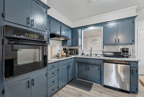 Cook like a pro in this stylish kitchen featuring a double oven, sleek stovetop, granite counters, and all the essentials—just bring your ingredients.