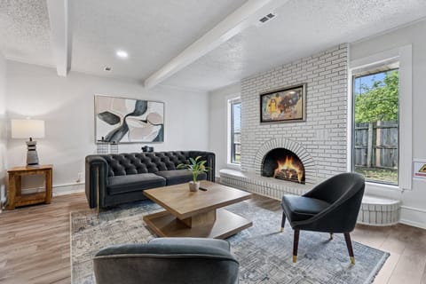 Unwind in this designer living room with plush seating and natural light. (Fireplace is not real or available for use)