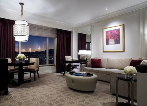 Unwind at dusk with sparkling city lights beyond windows.