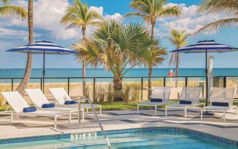 Soak up ocean breezes from loungers beside the shimmering pool.