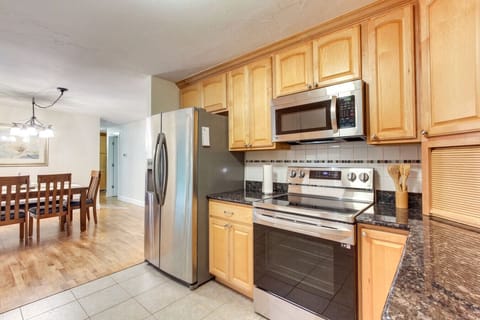 Kitchen | Stainless Steel Appliances, Warm Wood Cabinetry & Open Dining Flow