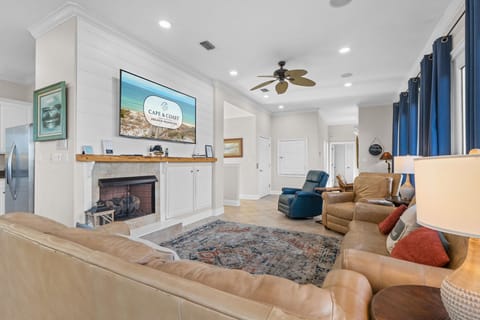 Unwind in your spacious living room with plush leather seating, cozy fireplace, and large TV for perfect movie nights together.