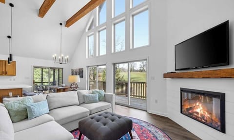 Open-concept layout, soaring ceilings & exposed wood beams