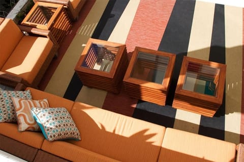 Stretch out on plush sofas in a shaded open-air lounge