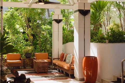 Unwind in a leafy patio lounge with shaded comfort.