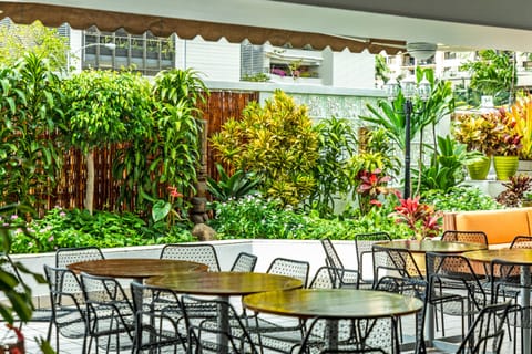 Dine outdoors amid vibrant landscaping and relaxed resort ambiance.