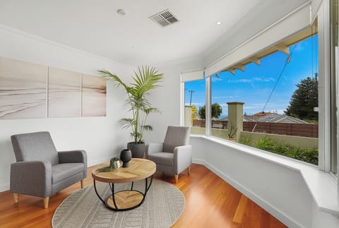Sunny sitting nook with cozy armchairs — ideal for morning coffee or a relaxing read