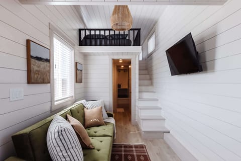 Relax in the inviting living room featuring a comfortable couch/sofa bed and a TV for entertainment. Stay connected with Wi-Fi access, making this space perfect for unwinding or enjoying your favorite shows and movies.