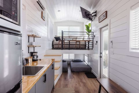 Bright, open-concept tiny home featuring a fully equipped kitchen, cozy loft lounge, additional sleeping space, and smart design that maximizes comfort near Zion National Park and Southern Utah.
