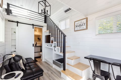 Relax in the inviting living room featuring a comfortable couch, a sofa bed for extra sleeping space, a cozy fireplace, and a TV. With Wi-Fi access, it’s the perfect spot to unwind or enjoy your favorite shows and movies in comfort.
