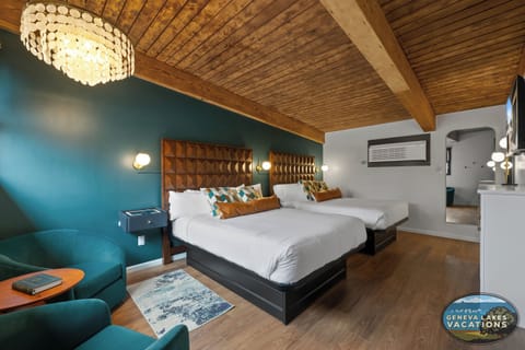 Two Queen Beds, seating for two. Nightstands are lit USB port, surface charging.