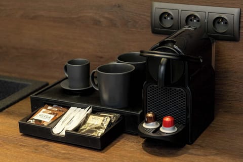 Coffee machine and tea set on kitchen counter.