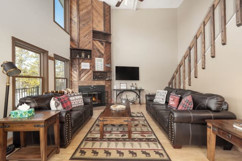 Sink into these plush leather sofas at 874 Kinnikinnick Road to enjoy your crackling fireplace, where rustic charm meets modern comfort in your mountain retreat.