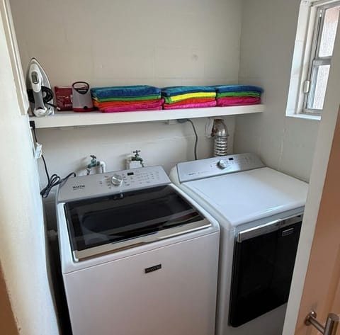 The laundry area is in the downstairs room with two twin beds. 